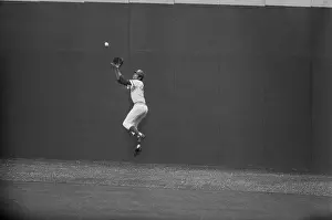Baseball Player Jumping to Catch Ball