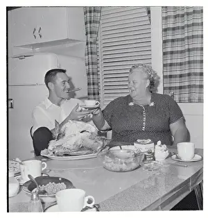 Baseball Player with his Mother in the Kitchen
