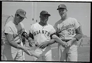 Baseball Players Discussing Baseball Bats