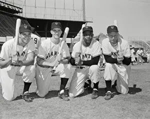 Baseball Players Kneeling with Bats