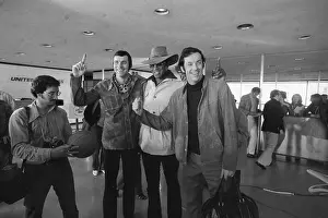 Prints of (Original Caption). Bill Bradley is shown standing with Willis Reed, (wearing hat), and other Knick players at an airport Hoops Through Time: A Visual Journey of Basketball History: Basketball Greats Walking Through Airport