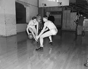Prints of Stanford basketball player Hank Luisetti dribbles right past his teammate, Jack Calderwood, during a workout at Stanford University Hoops Through Time: A Visual Journey of Basketball History: Basketball Player Hank Luisetti in Practice