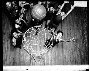 Prints of Group of unidentified basketball players standing beneath a basketball hoop on a basketball court, Chicago, Illinois, 1929 Courtside Vibes: Stunning Basketball Prints: Basketball Players