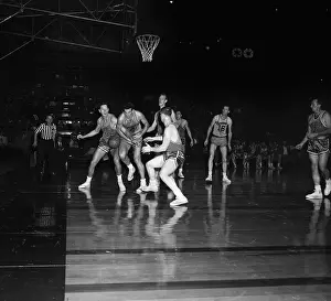 Basketball Players Competing for the Ball