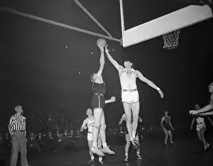 Basketball Players Competing in Game