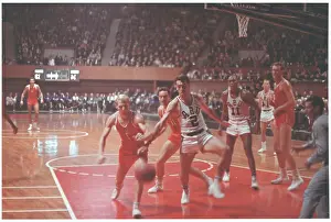 Basketball Players Fighting for Ball