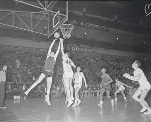 Basketball Players Going up at the Basket
