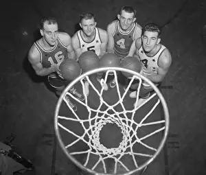 Basketball Players Posing Underneath the Net