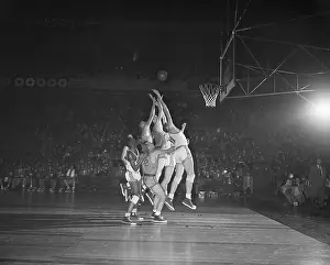 Basketball Players Reaching for the Ball