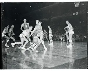 Basketball Players Scrambling for the Ball