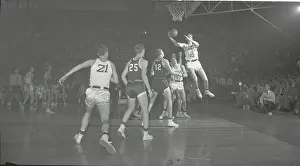Basketball Players Vie for Ball