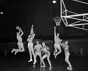 Basketball Players Vie for Ball