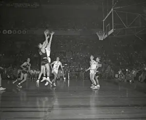 Basketball Players Vie for Ball