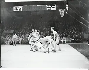 Prints of (Original Caption). Football On the Basketball Court Hoops Through Time: A Visual Journey of Basketball History: Basketball Scrimmage