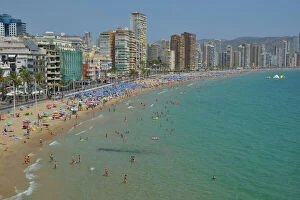 Tourist Gallery: Bathers in front of big hotels on Playa Levante, Benidorm, Costa Blanca, Spain beach