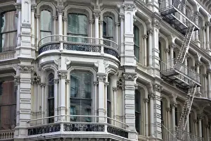 Bay window of typical cast iron building with fire escapes in Chelsea, New York City