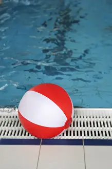 Basin Prints: Beach ball at the edge of a swimming pool