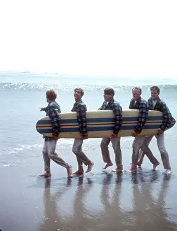 Beach Boys On The Beach With A Surfboard