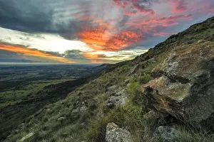 Beautiful Sunset from the top of the Magaliesberg Mountain Range looking towards the flat expanse of the agricultural North-West Province. Magaliesberg Mountain, North-West Province, South Africa