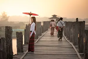 Silk Prints: Beautiful woman holding traditional red umbrella and walking on U Bein Bridge, Myanmar