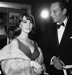 Prints of American actress Natalie Wood (1938 - 1981) with producer Arthur Loew Jr. (1925 - 1995) at the premiere of the film Becket, USA, 1964. (Photo by Archive Photos/Getty Images) Grace, Glamour & Timeless Elegance: Becket Premiere