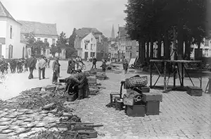 Prints of circa 1910: Pedestrians pass the temporarily closed stalls of a street market in Belgium. (Photo by F J Mortimer/Getty Images) Francis James Mortimer (1874-1944) Prints: Belgian Market