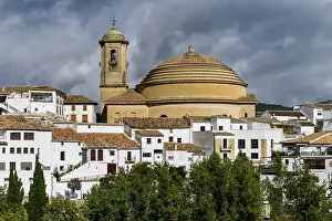 Bell tower and domed roof of Iglesia de la Encarnacion church with white houses below