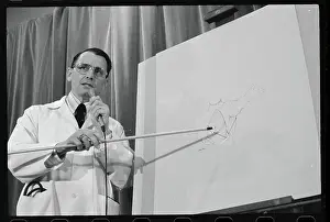 Benjamin Aaron Pointing to Diagram