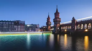 Blue Hour Prints: Berlin Oberbaum Bridge with traces of light from ship and train in the evening
