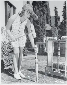 Bette Davis Setting up Croquet Game