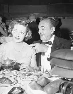 Jack L Prints: Bette Davis at Table with Jack Warner