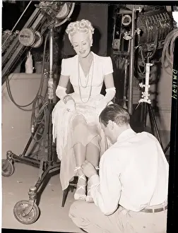 Betty Grable Having Her Shoe Laces Tied