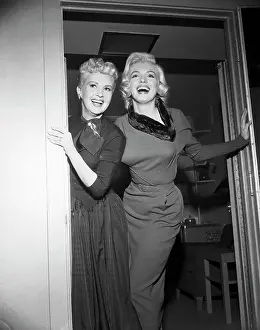 Betty Grable and Marilyn Monroe Standing in Doorway Together