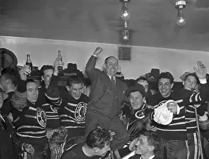Prints of The Chicago Black Hawks are shown as they carried Manager Bill Stewart on their shoulders in the parade to the dressing room after they had defeated the Toronto Maple Leafs, 4-1 Frozen Moments: A Journey Through Hockey History: Black Hawks Celebrate Stanley Cup Victory