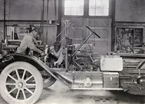 Black Mechanics Working On Car In Garage