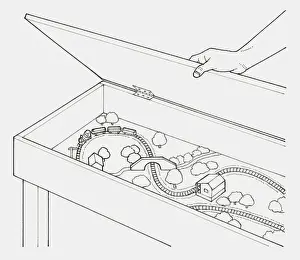 Storage Prints: Black and white illustration of hand opening lid of a box containing a train set
