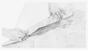 Storing Prints: Black and white illustration of hands wrapping a bunch of dried flowers in newspaper (storing dried flowers)
