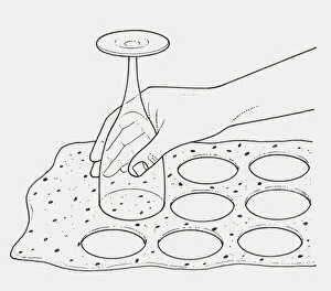 Black and white illustration of using upturned wine glass to cut pastry