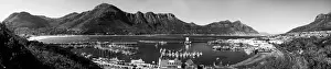 Fishing Boats Prints: A black and white panoramic picture of Hout Bay with Hout Bay Beach on the left and the marina