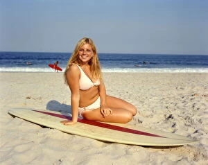Iconic Bikini Collection: Blond Blonde Woman Young Pink Bikini Sitting On Beach Lean Surf Board