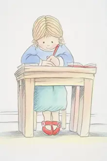 Blonde girl in green skirt, blue jumper and red shoes sitting by small desk and writing, low angle view