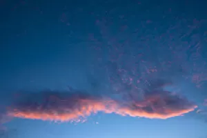 Blue sky with a pink cloud, sunset