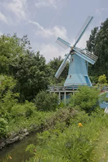 Traditional Windmills Gallery: Blue Windmill in a Gordon with River against Blue Sky