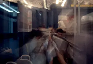 Prints of NEW YORK, NY - JANUARY 1959: A blurred motion image of passengers on the New York City subway with vintage ads in the background in January 1959 in New York City, New York Portraits, Artworks, and Montages from a Visionary Photographer: Blurred Motion Image of Passengers on the New York City Subway in the 1950's