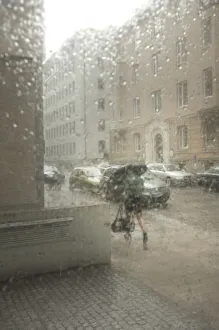 Dripping Gallery: Blurred street atmosphere through a window pane with rain drops
