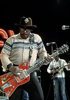 Prints of CIRCA 1976: Guitarist Bo Diddley plays his Gretsch electric guitar as he performs on a TV show in circa 1976. (Photo by Michael Ochs Archives/Getty Images) Bo Diddley: Rhythm & Riffs Prints: Bo Diddley Performs On A TV Show