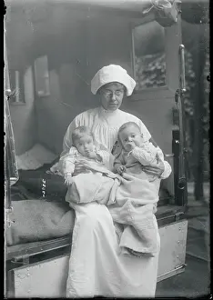Caring Prints: Board of Health Nurse Holding Babies