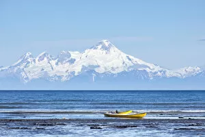 Volcano Collection: Boat on the beach of Kenai, Mt Redoubt volcano at the back, Kenai, Alaska, United States