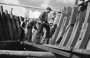 Prints of 25th August 1945: Workers in Rye using traditional materials and techniques to build wooden hulled boats for the Navy. Original Publication: Picture Post - 2072 - A Strange Contrast - pub Francis Reiss: Early Visions from Picture Post: Boat Building