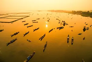 Boats in Tam Giang lagoon in sunrise from drone. Hue, Vietnam